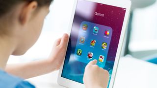 Girl playing games on an iPad