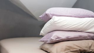 picture of piled pillows with varying pillowcases on them