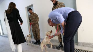 Princess Catherine and Prince William with golden labrador puppies Salto and Sky as they visit an Army Canine Centre in Pakistan