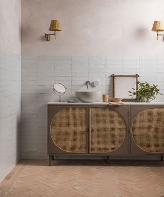 Terracotta tiles in bathroom, wooden cabinet, white wall tiles, cabinet decorated with mirror and accessories