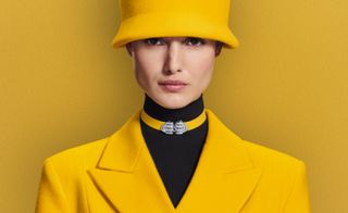model wears Boucheron diamond jewellery against yellow backgrounds