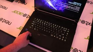 Acer Predator Triton 17 X; a hand touches the keyboard of a laptop