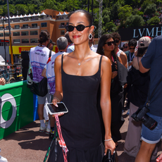 Photo of Alexandra Saint-Mleux wearing black dress at Formula 1 race.
