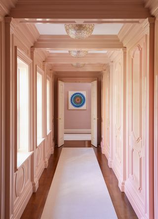 pink hallway with historic architectural details