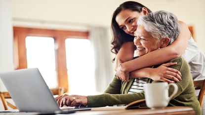 A granddaughter and grandmother look at life insurance and annuity products online.