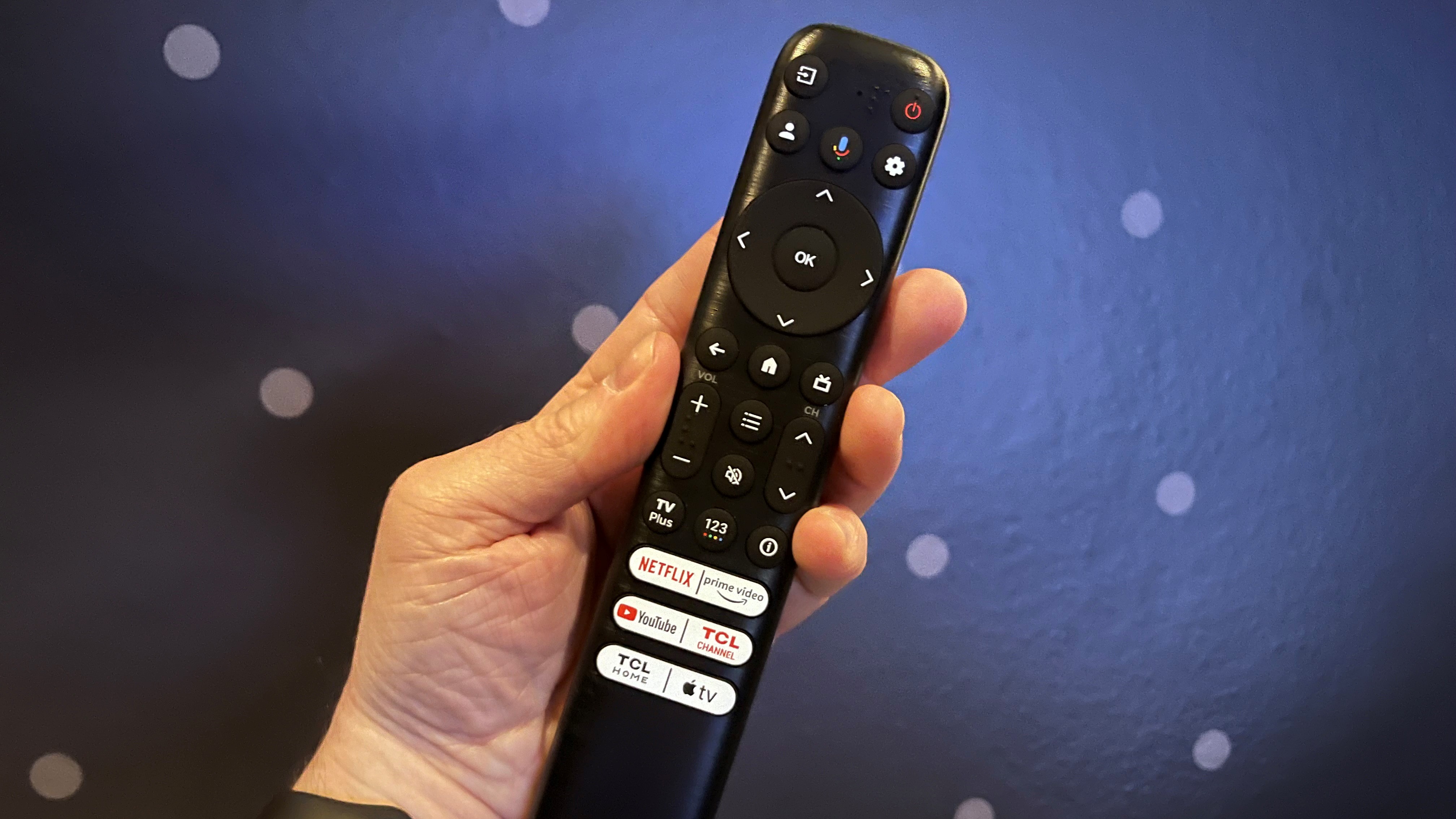 TCL QM8 remote control held in hand