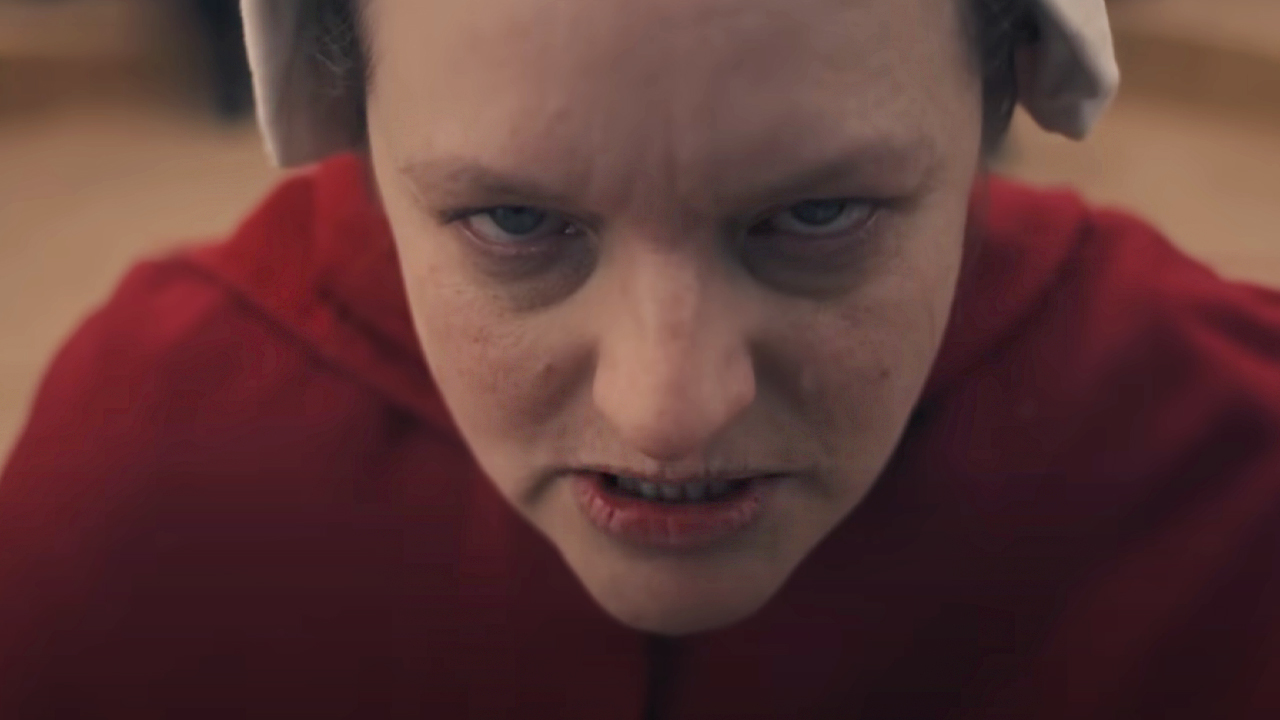 Elixabeth Moss in extreme closeup and red Handmaid outfit, in the Handmaid&#039;s Tale.