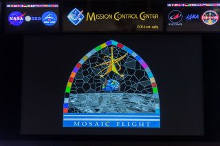 The front screen in the International Space Station control room at Johnson Space Center in Houston displays the Mosaic Flight patch, representing flight director Fiona Turett and her team, as designed by Turett and artist Tim Gagnon.