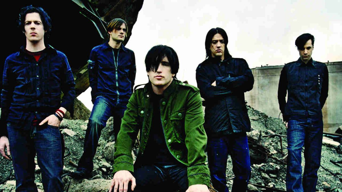 Nine Inch Nails sitting on a rocky outcrop in 2005