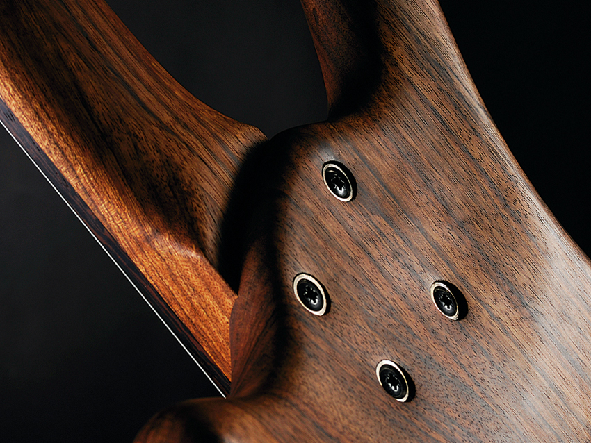 The back is concaved where body and neck meet to aid upper fret access.