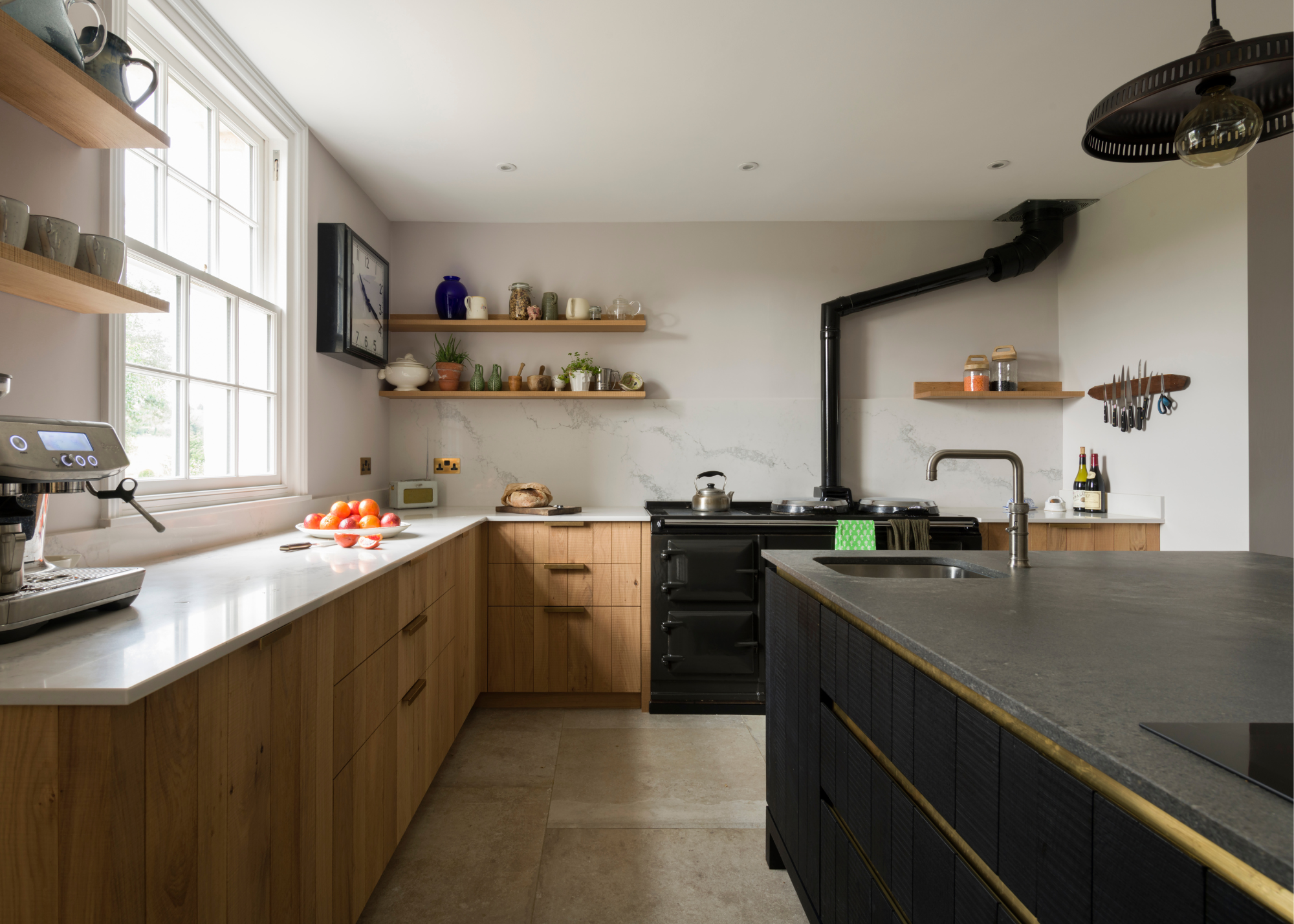 kitchen with black aga, black island and sawn timber cabinetry