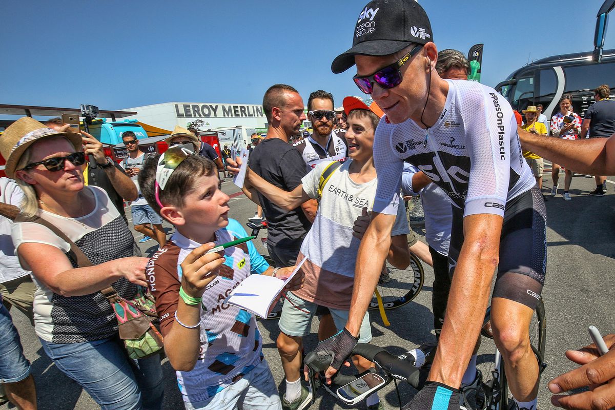 Chris Froome stops to sign an autograph
