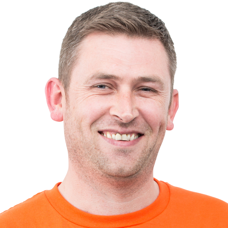 male with short brown hair wearing orange top