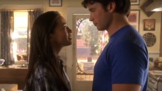 Kristin Kreuk as Lana Lang looking up at Tom Welling as Clark Kent on Smallville