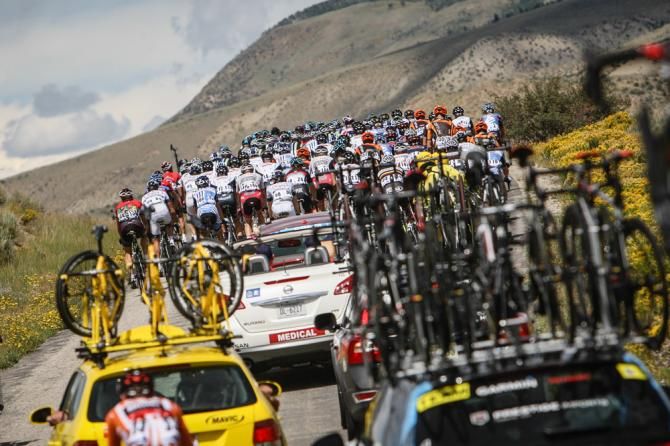 The peloton bunches up as they hit rolly hills.