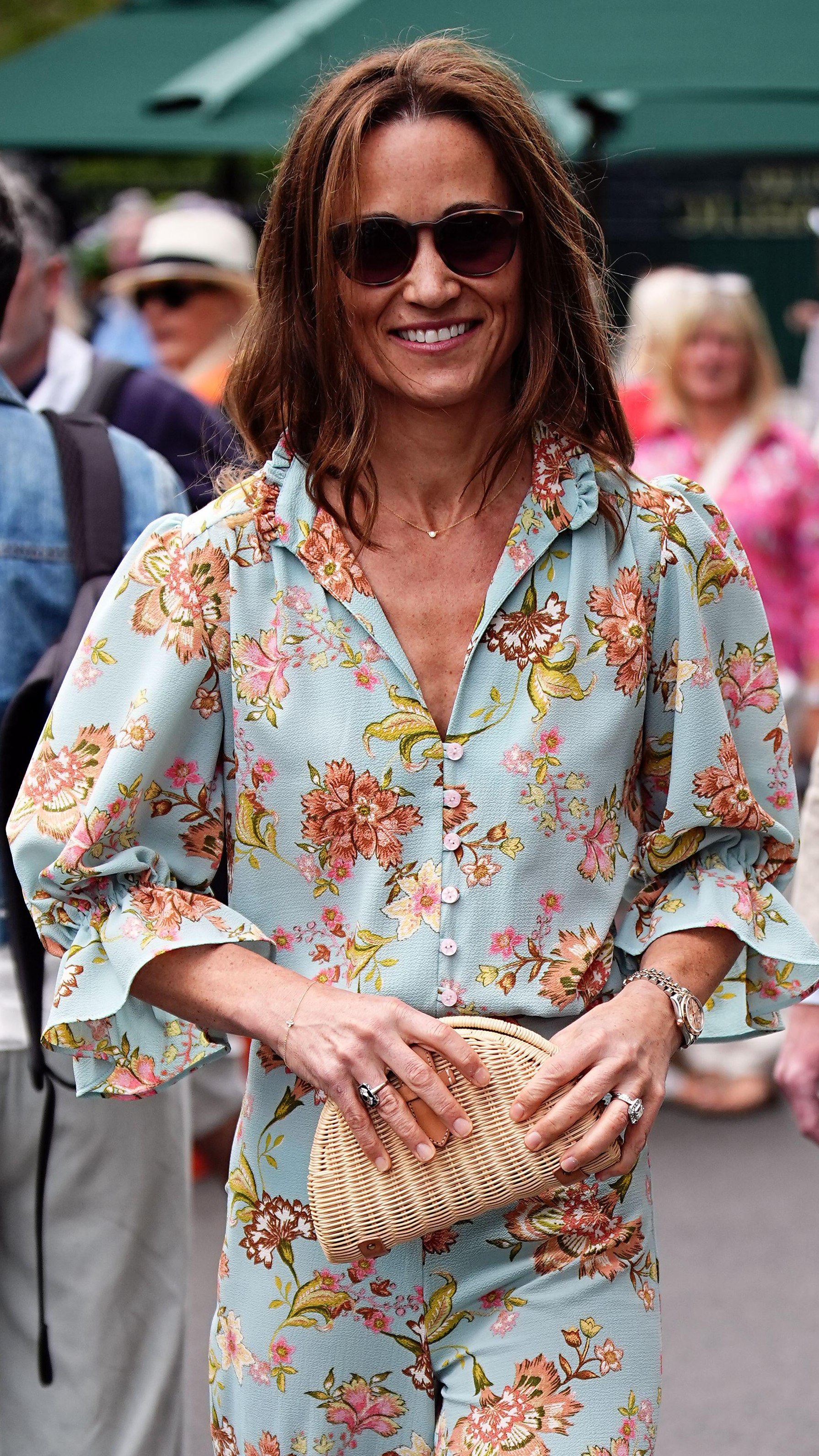 Pippa Middleton smiles, carrying a clutch bag, as she arrives at Wimbledon 2024