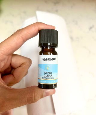 Person holding Tisserand aromatherapy oil