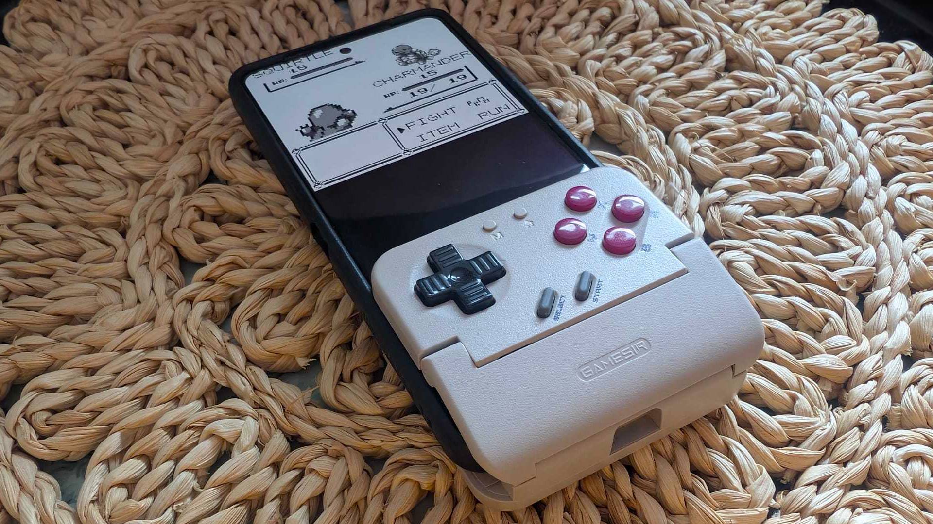 GameSir Pocket Taco on wicker table cover attached to Asus ROG Phone 8 Pro with Pokemon gameplay on screen featuring Charmander and Squirtle.