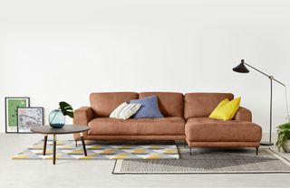 A tan leather chaise sofa in a modern living room
