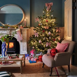 Dark blue painted living room decorated with Christmas tree and festive decorations