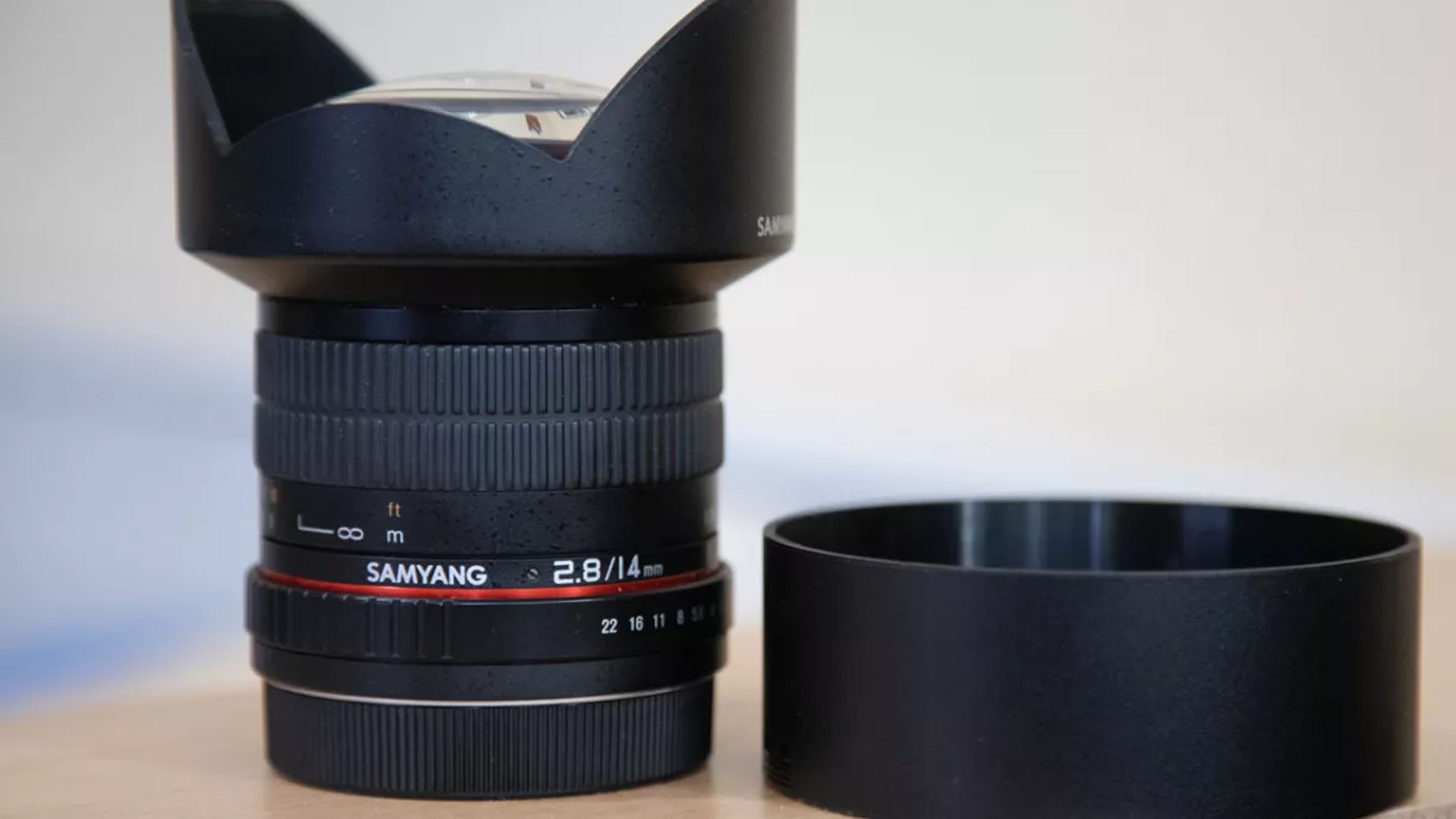 Rokinon/Samyang lens on wooden table