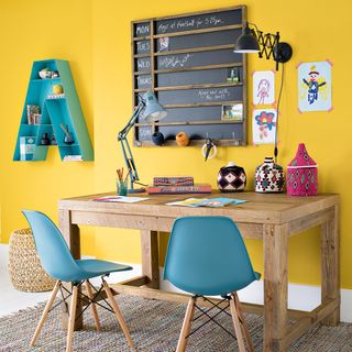 home office with yellow wall and desk lamp
