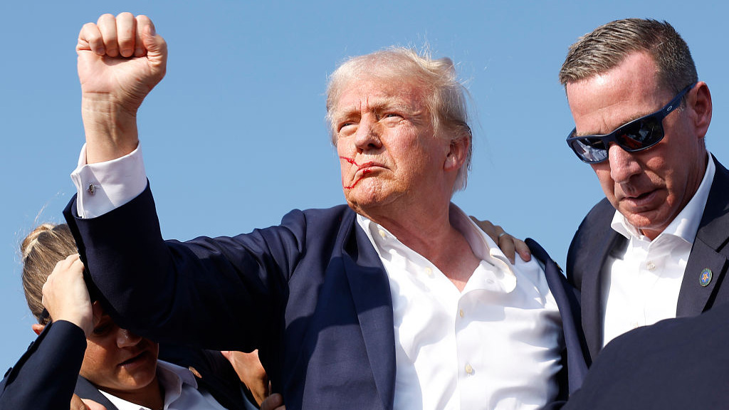 BUTLER, PENNSYLVANIA - JULY 13: Republican presidential candidate former President Donald Trump is rushed offstage by U.S. Secret Service agents after being grazed by a bullet during a rally on July 13, 2024 in Butler, Pennsylvania. Butler County district attorney Richard Goldinger said the shooter is dead after injuring former U.S. President Donald Trump, killing one audience member and injuring another in the shooting. (Photo by Anna Moneymaker/Getty Images)