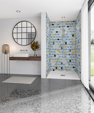 A bathroom idea with tiled flooring (hexagonal motif) and colorful bathroom panels in blue and yellow in shower enclosure