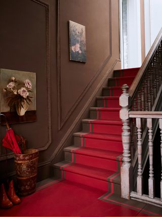 painted brown stairwell with red carpet