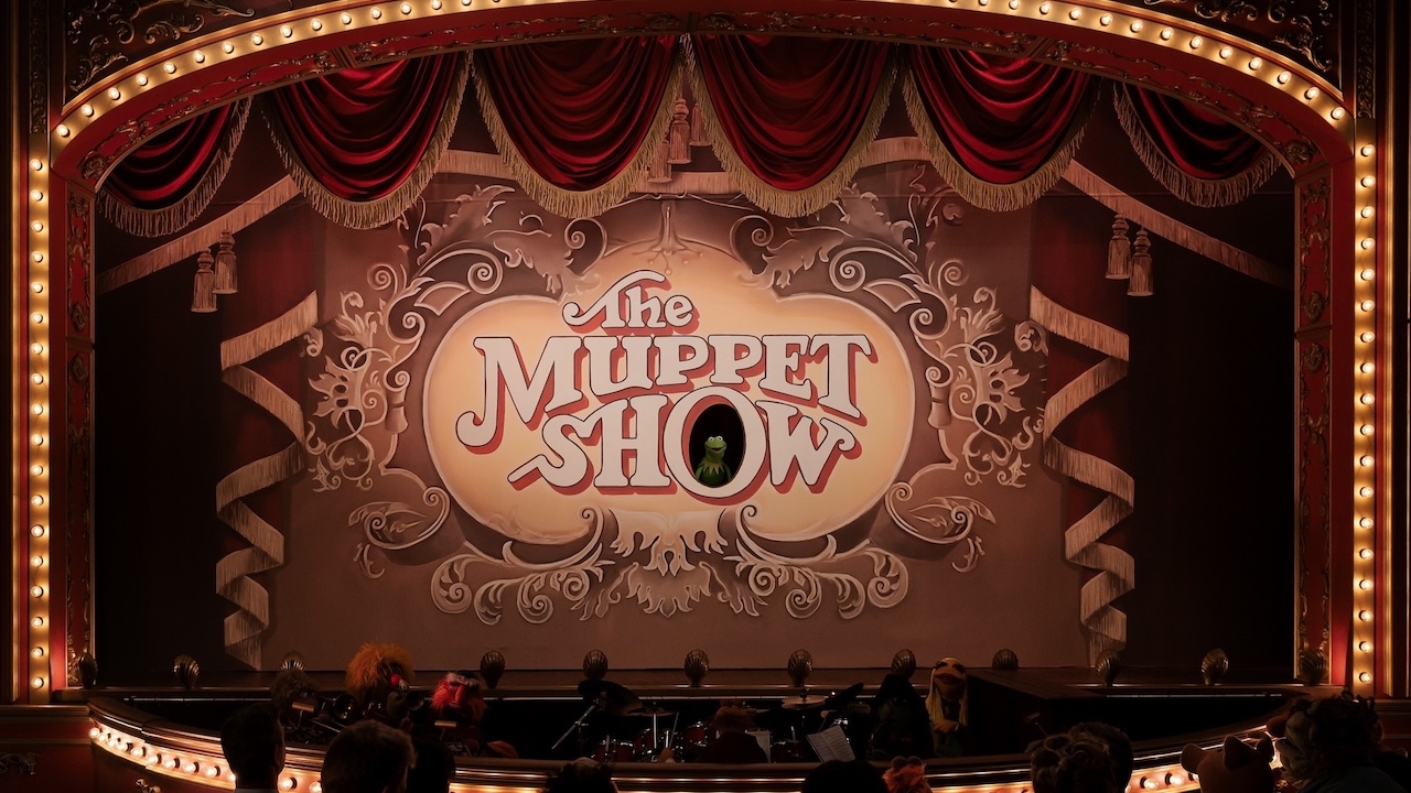 Kermit inside of the "O" in The Muppet Show backdrop