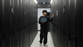 Chinese man working in a datacenter.
