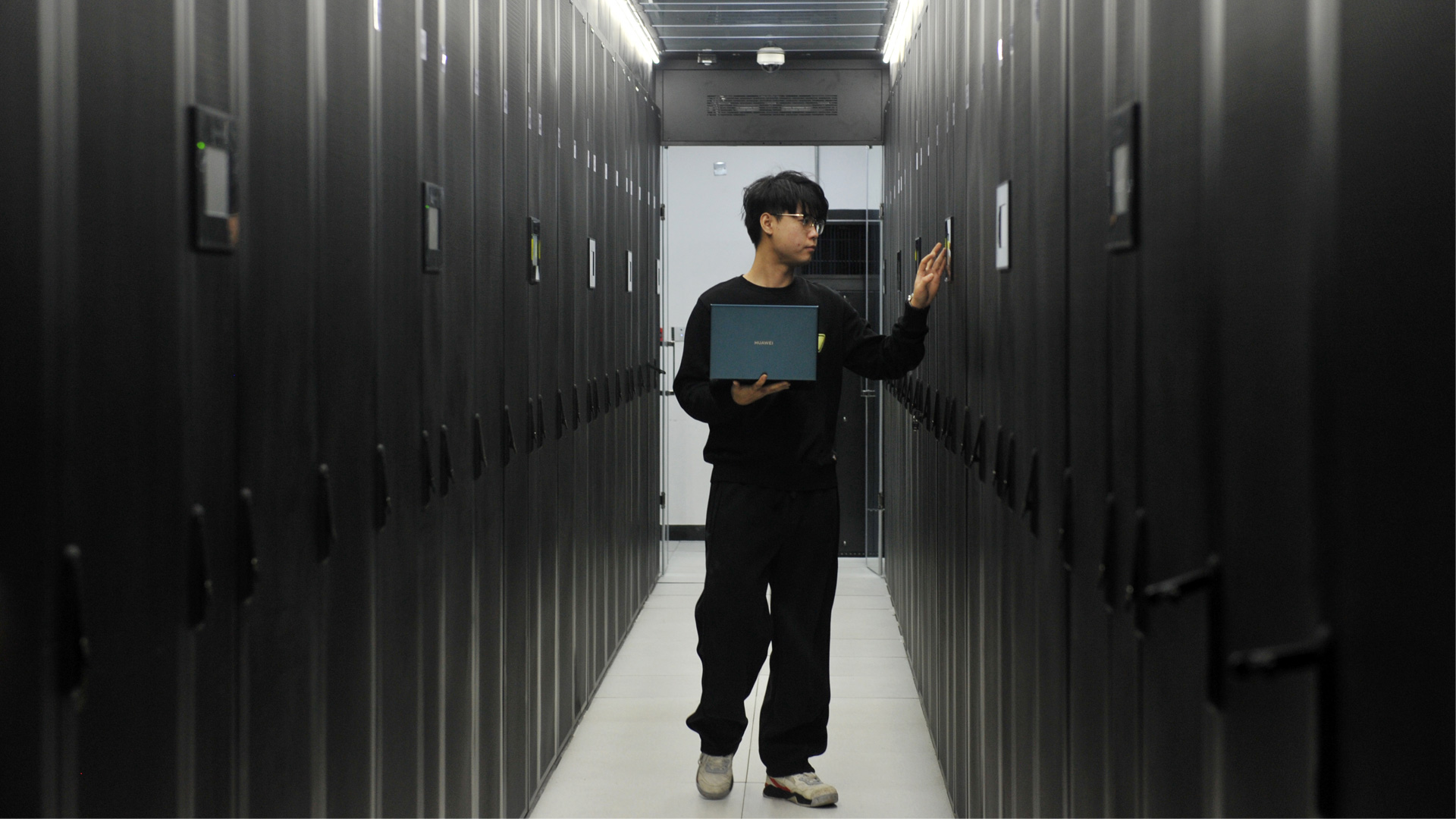 Chinese man working in a datacenter.
