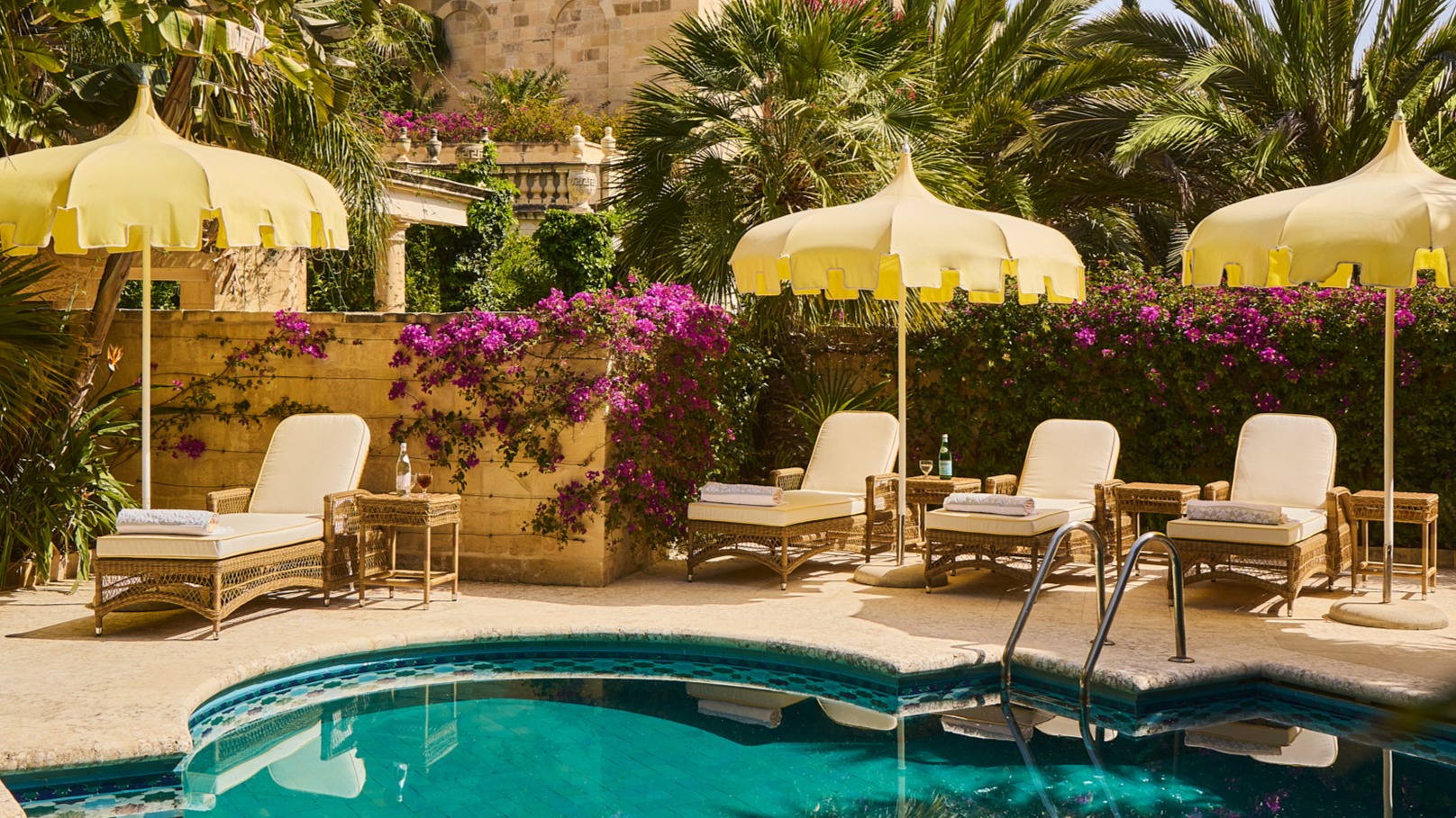 Hotel pool with yelllow parasols