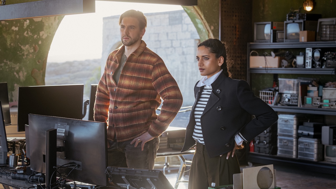 Boris and Claudette looking at series of computer screens in NCIS: Tony &amp; Ziva