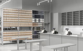 At the Arket store, products are displayed cross cool grey shelves and rails