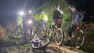 A group of mountain bikers having a rest on a night ride