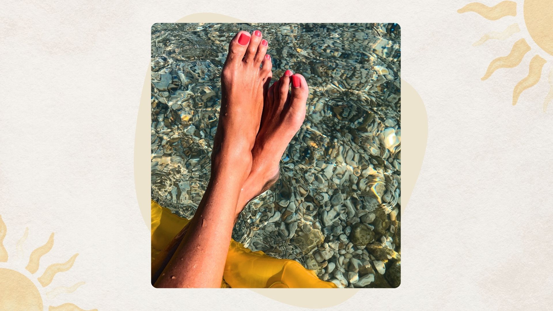 a woman's feet dangling over a blue sea with pebbles beneath, with a pink pedicure