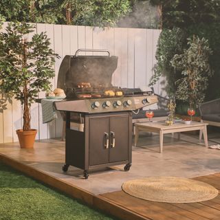 A gas barbecue on outdoor decking