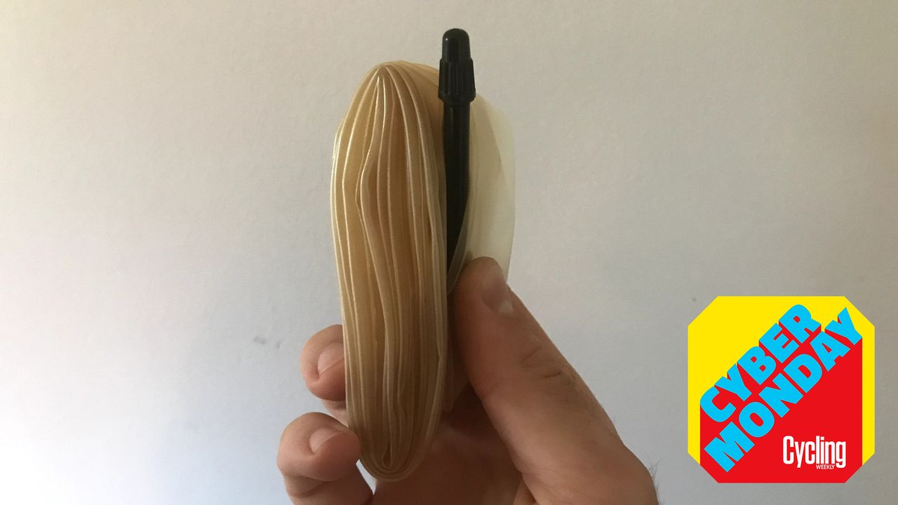 hand holding a TPU inner tube with the Cycling Weekly Cyber Monday roundel