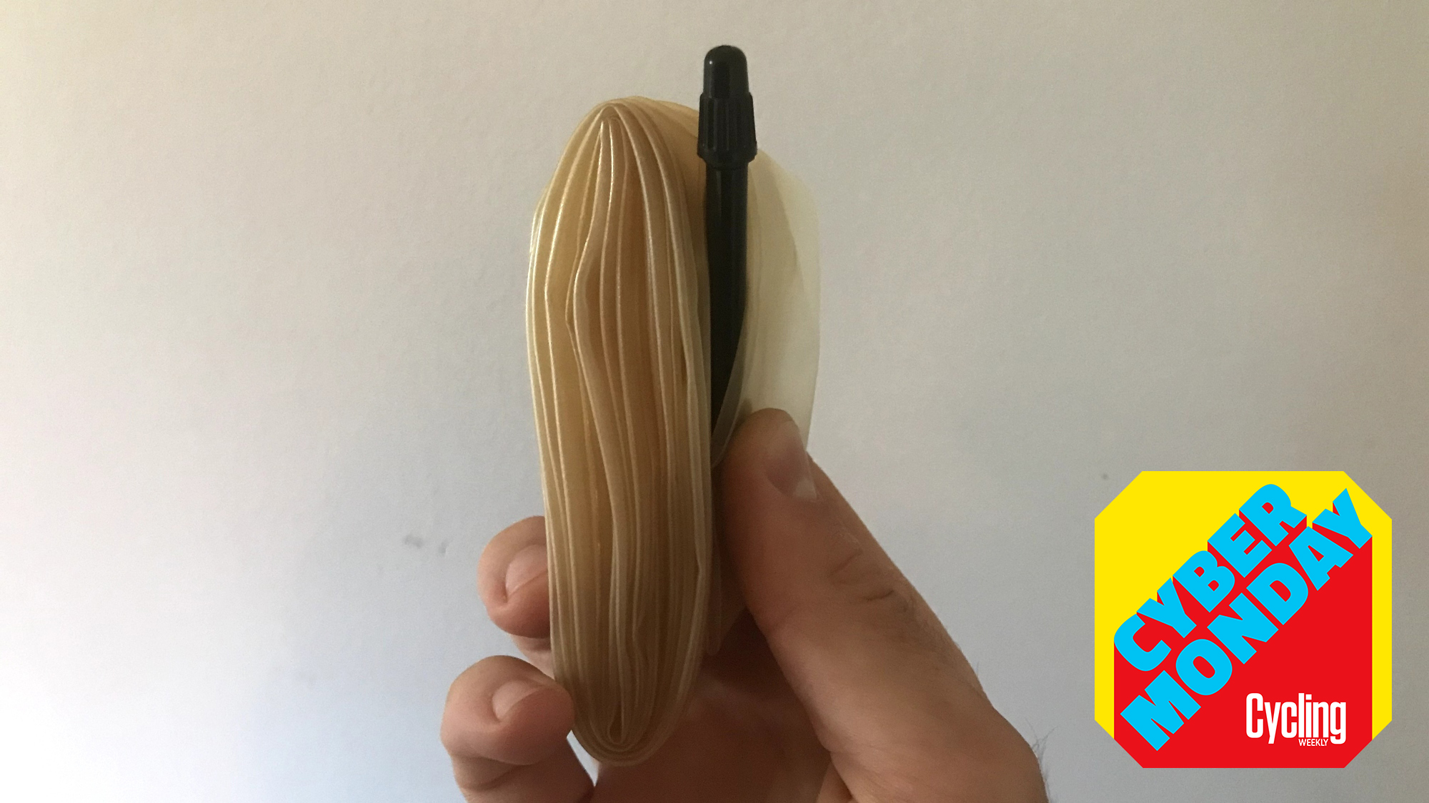 hand holding a TPU inner tube with the Cycling Weekly Cyber Monday roundel