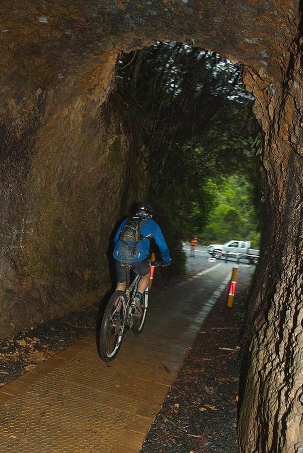 View from within. a time trialist exits the century old Spray Tunnel, a highlight of the Zeehan Time Trial stage.
