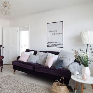 living room with white walls and sofa with cushions