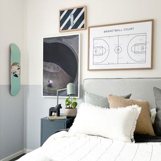 neutral boys bedroom with framed artwork and skateboard