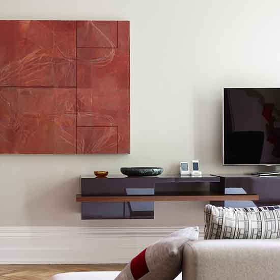 seating area with tv console and white wall