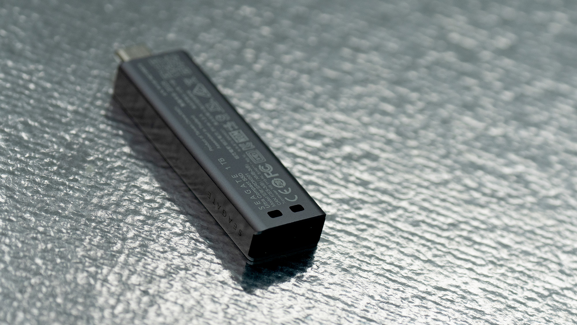 Seagate Ultra Compact SSD on a glass background.