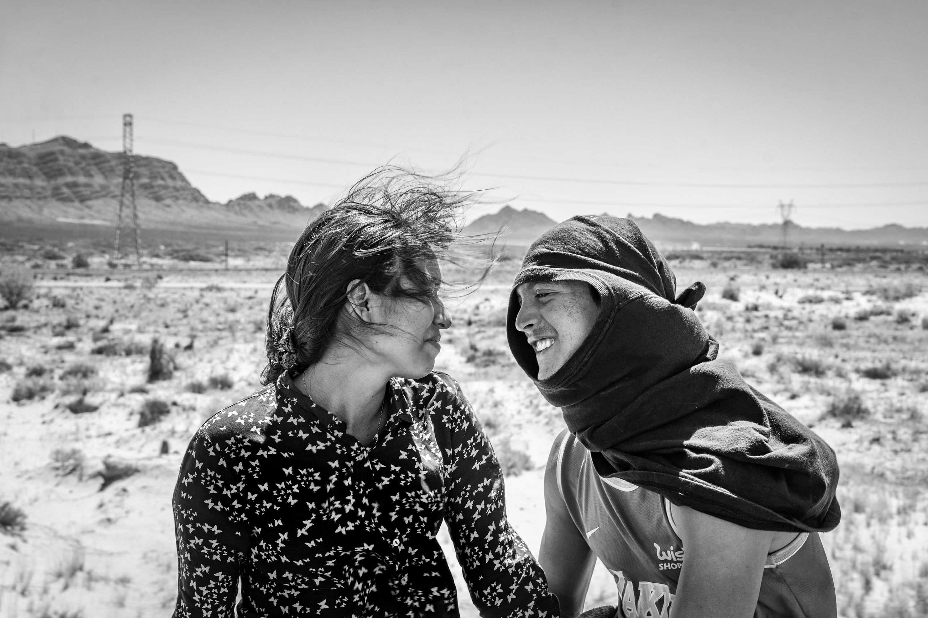 Ruben Soto (right) a migrant from Venezuela, with Rosa Bello, a Honduran migrant, on top of the train known as “The Beast”. Samalayuca, Mexico 2023. From the series “The Two Walls”