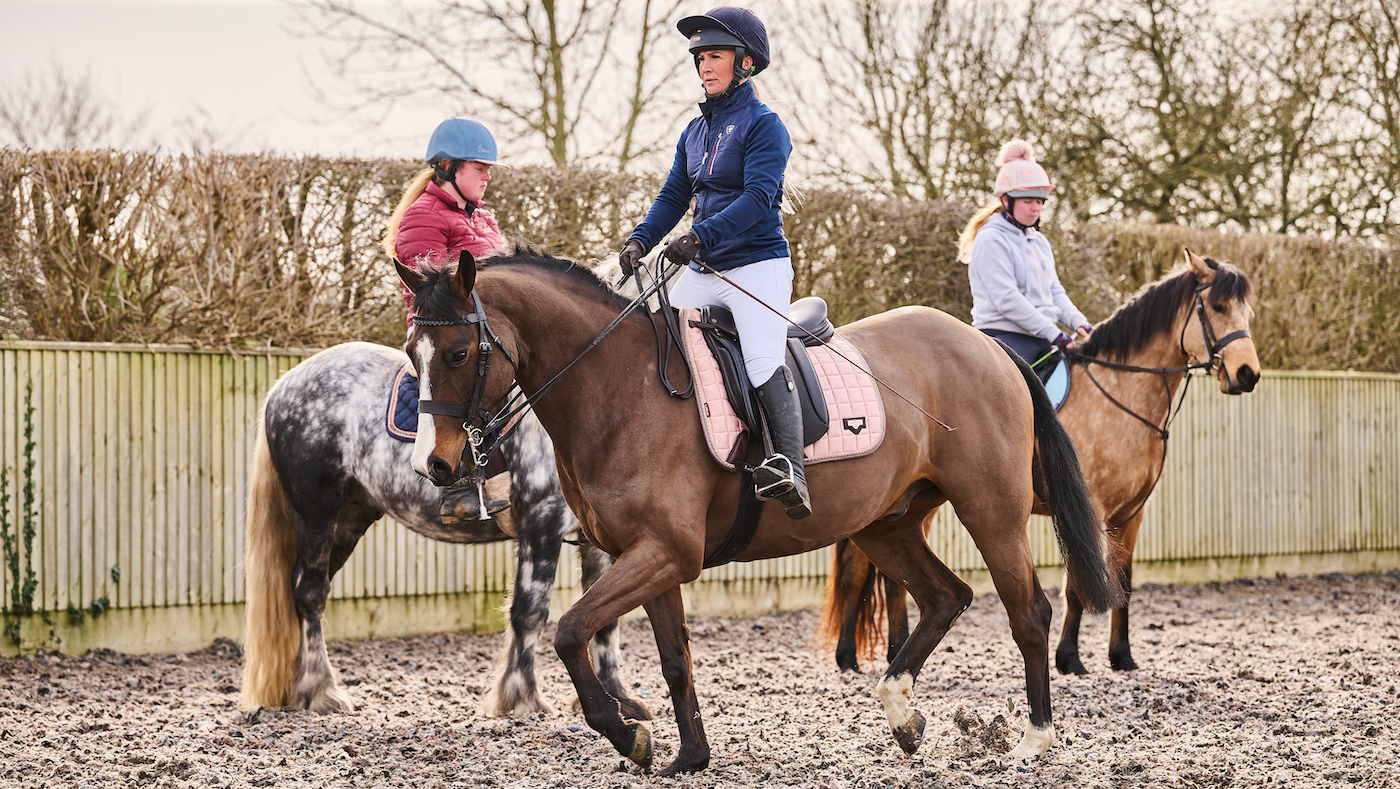 Riding in front of other horses, to simulate the individual performance in the show ring