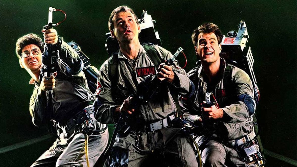 Three men in jumpsuits hold neutrona wands while wearing proton packs