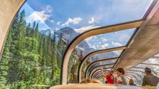 Rocky Mountaineer train traveling through the Rocky Mountains with luxury dining on board