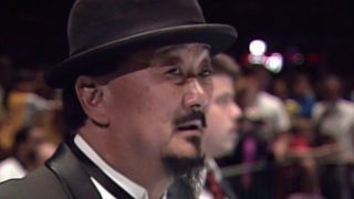 Mr. Fuji in black hat during WWE match